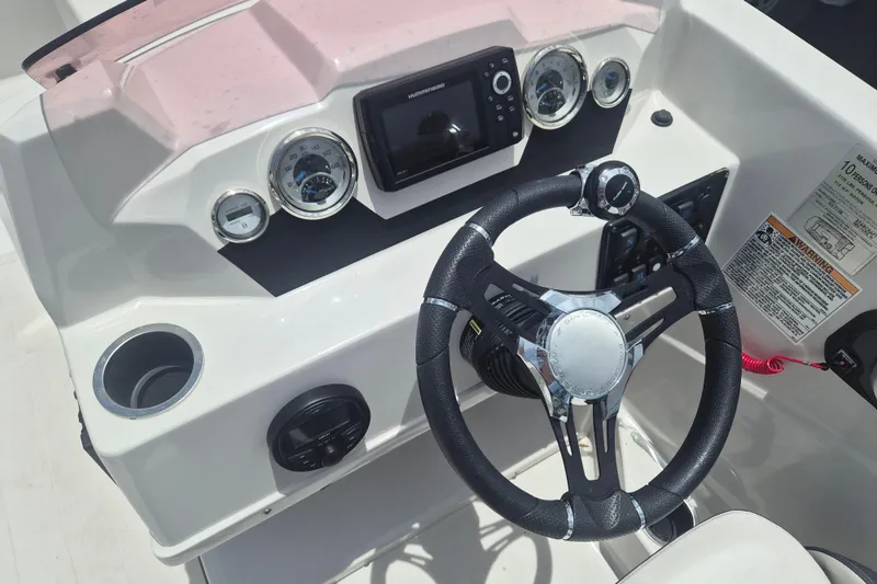 Slide: The Image of Steering console of 2022 Starcraft SVX 171 OB boat with gauges and controls. - 12
