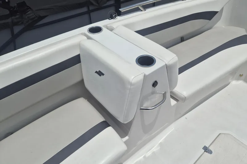 Slide: The Image of 2022 Starcraft SVX 171 OB boat interior with white seating and cup holders. - 16
