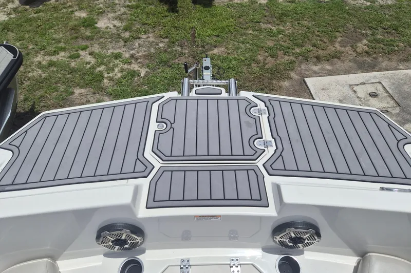 Slide: The Image of 2022 Starcraft SVX 171 OB boat deck with gray non-slip surface and speakers. - 20
