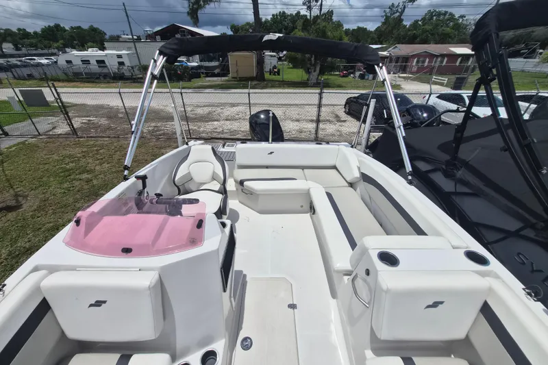 Slide: The Image of 2022 Starcraft SVX 171 OB boat with seating and canopy, parked outdoors. - 22