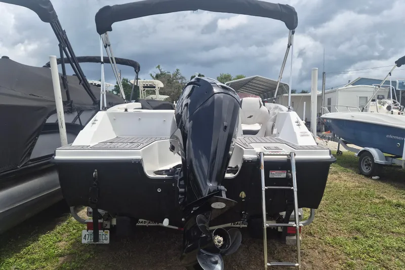 Slide: The Image of 2022 Starcraft SVX 171 OB boat with outboard motor and ladder, parked outdoors. - 3
