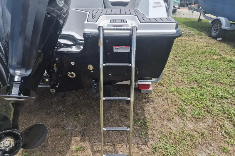 Slide: The Image of 2022 Starcraft SVX 171 OB boat with ladder and outboard motor on grassy area. - 4