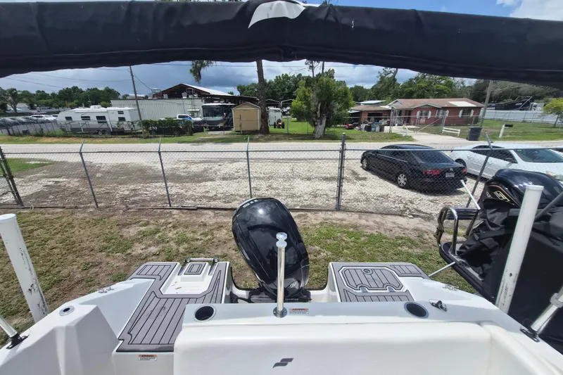 Slide: The Image of 2022 Starcraft SVX 171 OB boat with outboard motor, parked near a fence. - 5