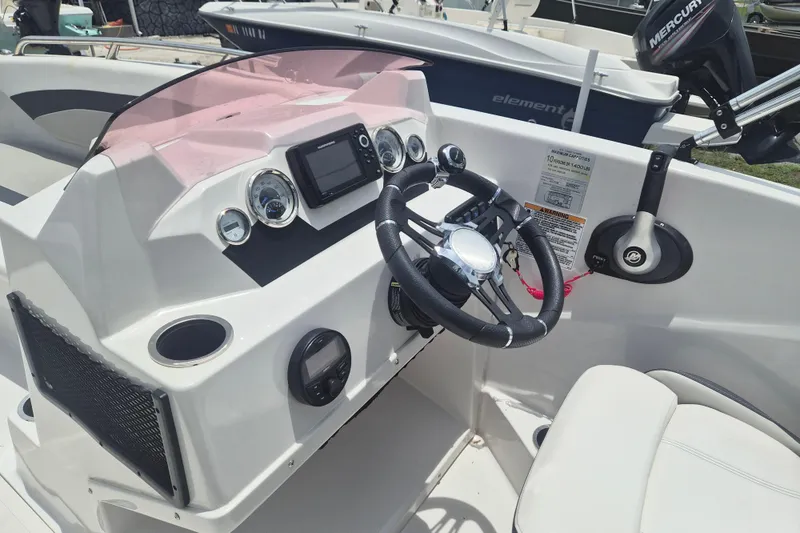 Slide: The Image of 2022 Starcraft SVX 171 OB boat dashboard with steering wheel and control panel. - 9