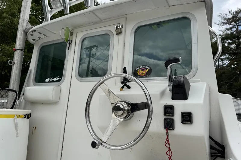 Slide: The Image of 2016 Steiger Craft 25 Chesapeake boat helm with steering wheel and controls. - 10