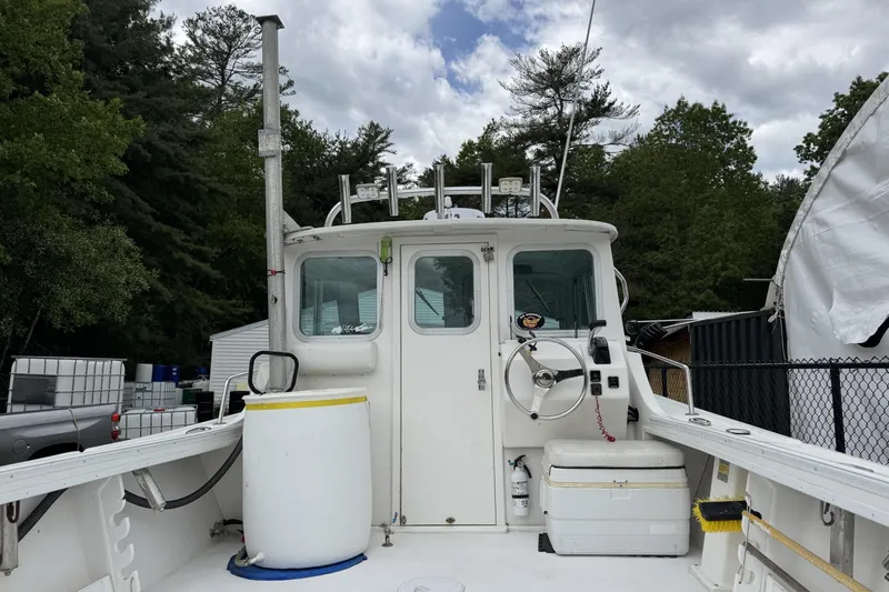 Slide: The Image of 2016 Steiger Craft 25 Chesapeake boat with cabin, docked outdoors. - 13
