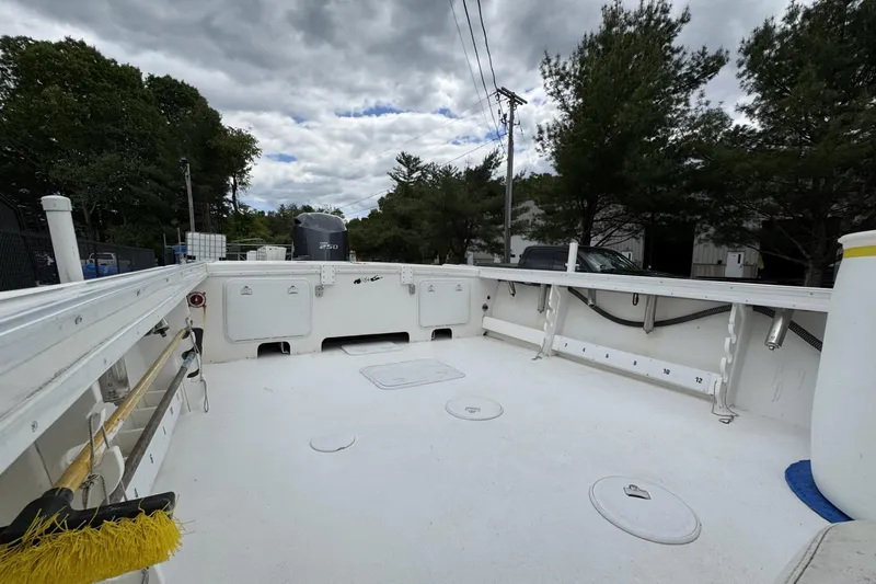 Slide: The Image of 2016 Steiger Craft 25 Chesapeake boat deck with storage compartments and outboard motor. - 14