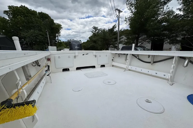 Slide: The Image of 2016 Steiger Craft 25 Chesapeake boat deck with storage compartments and fishing rod holders. - 15