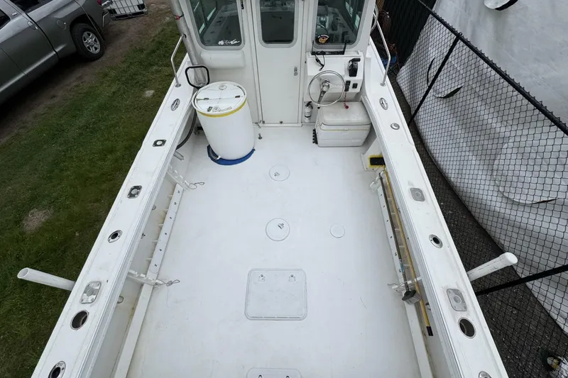 Slide: The Image of 2016 Steiger Craft 25 Chesapeake boat deck with fishing rod holders and storage compartments. - 20