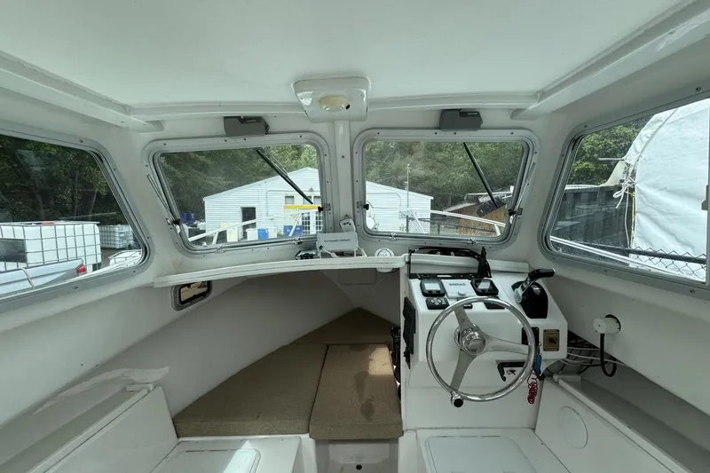 Slide: The Image of 2016 Steiger Craft 25 Chesapeake boat interior with steering wheel and dashboard controls. - 21