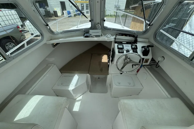 Slide: The Image of 2016 Steiger Craft 25 Chesapeake boat interior with steering wheel and seating. - 23