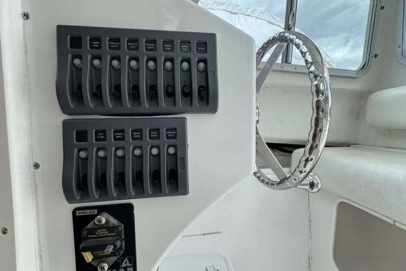 Slide: The Image of Control panel and steering wheel of 2016 Steiger Craft 25 Chesapeake boat. - 25