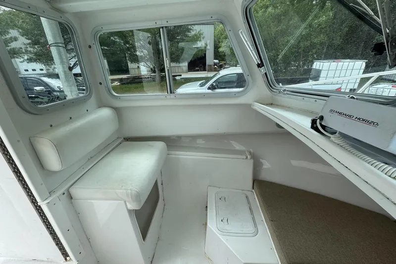 Slide: The Image of 2016 Steiger Craft 25 Chesapeake cabin interior with seating and navigation equipment. - 26