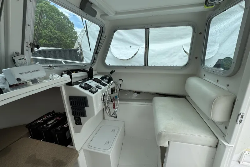 Slide: The Image of Interior of 2016 Steiger Craft 25 Chesapeake boat, featuring helm and seating area. - 27