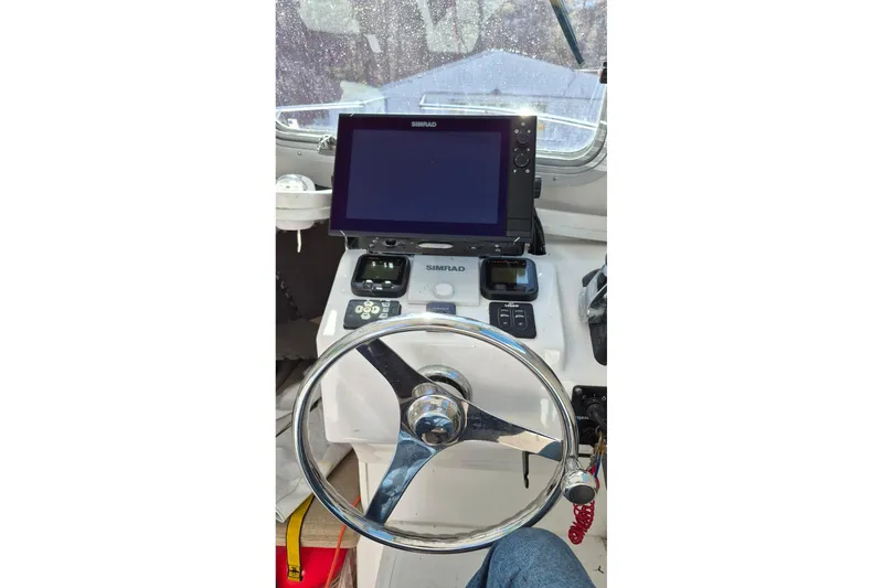 Slide: The Image of Steering wheel and navigation system of 2016 Steiger Craft 25 Chesapeake boat. - 28