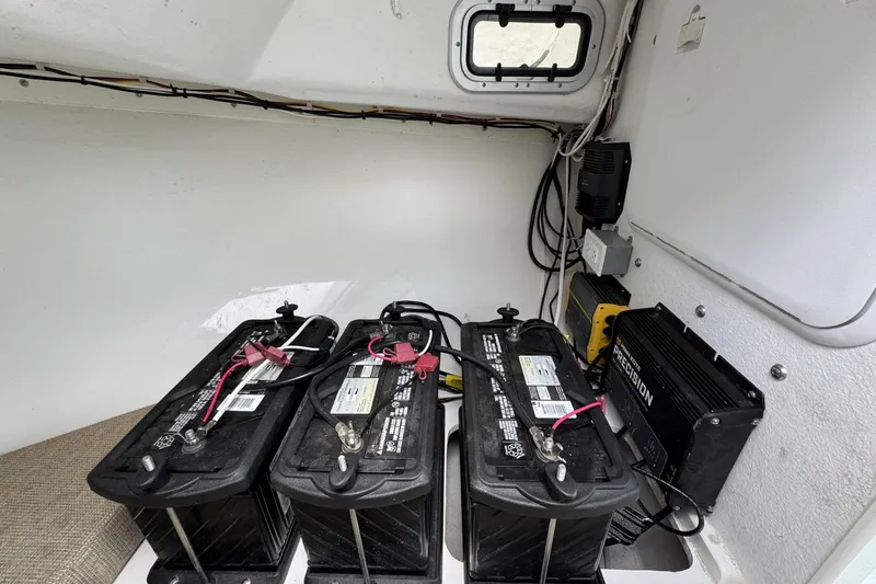 Slide: The Image of Battery compartment of 2016 Steiger Craft 25 Chesapeake boat, featuring three batteries and wiring. - 29
