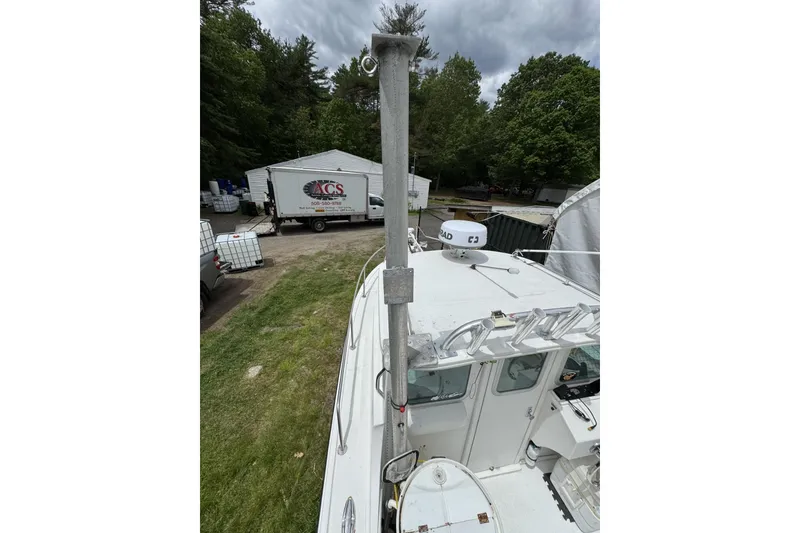 Slide: The Image of 2016 Steiger Craft 25 Chesapeake boat with radar, docked near a wooded area. - 33