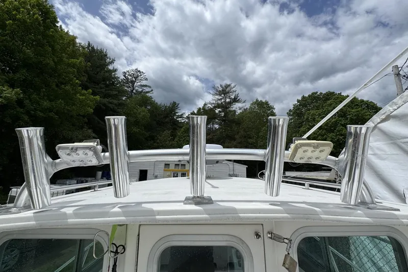 Slide: The Image of 2016 Steiger Craft 25 Chesapeake boat with rod holders and LED lights under cloudy sky. - 34