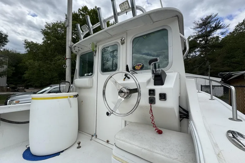 Slide: The Image of 2016 Steiger Craft 25 Chesapeake boat helm with steering wheel and controls. - 9
