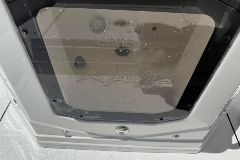 Slide: The Image of Avid 21 Mag 2026 boat compartment with water droplets on transparent cover. - 10