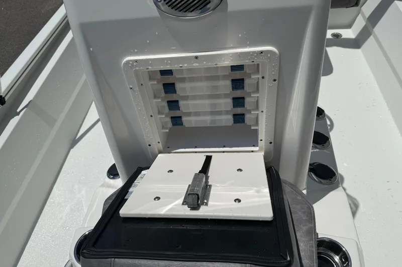 Slide: The Image of Open storage compartment on 2026 Avid 21 Mag boat, featuring organized slots and sleek design. - 11