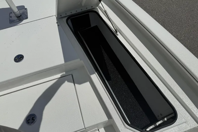 Slide: The Image of Open storage compartment on 2026 Avid 21 Mag boat deck. - 13