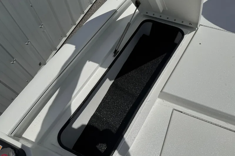 Slide: The Image of Open storage compartment on 2026 Avid 21 Mag boat deck. - 14
