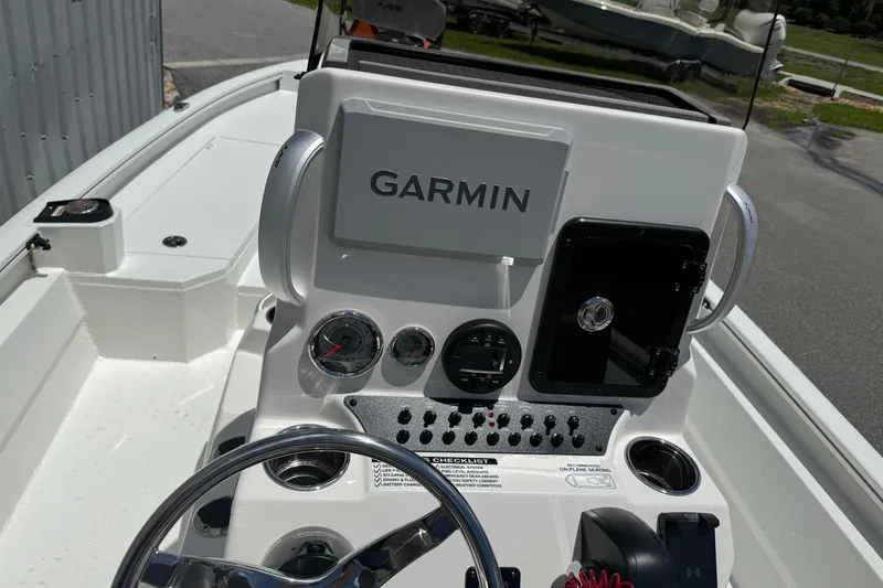 Slide: The Image of 2026 Avid 21 Mag boat dashboard with Garmin navigation system and control panel. - 16