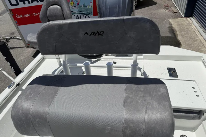 Slide: The Image of Avid 21 Mag 2026 boat seat with gray upholstery and rod holders. - 18