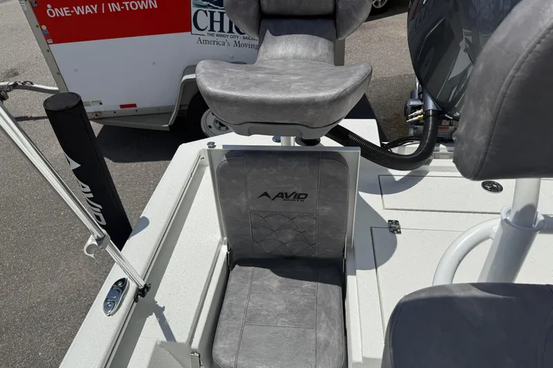 Slide: The Image of 2026 Avid 21 Mag boat interior with gray seating and visible equipment. - 21