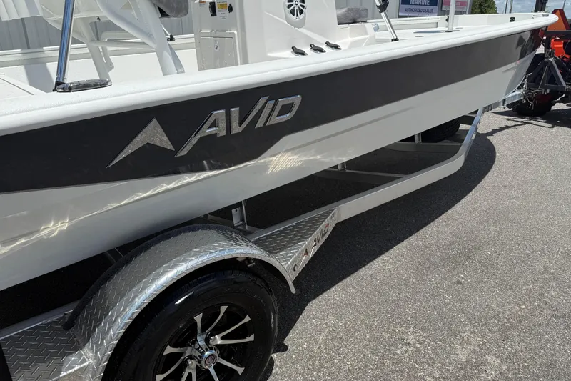 Slide: The Image of Avid 21 Mag 2026 boat on trailer, showcasing sleek design and branding. - 4