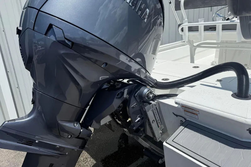 Slide: The Image of Avid 21 Mag 2026 boat with Yamaha outboard motor, docked outdoors. - 5