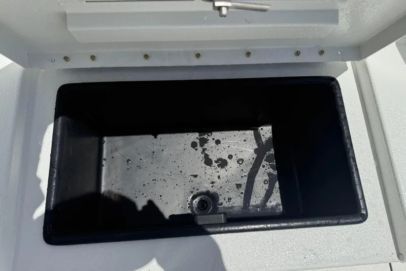 Slide: The Image of Open storage compartment on Avid 21 Mag boat, 2026 model, with water droplets inside. - 9