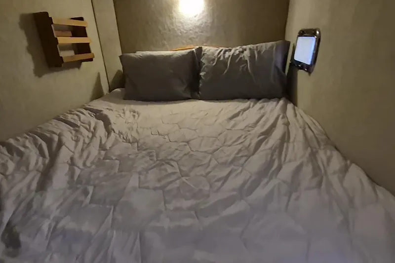 Slide: The Image of Cozy cabin bed in 2009 Endeavour 40 Skylounge yacht, with soft lighting and pillows. - 13