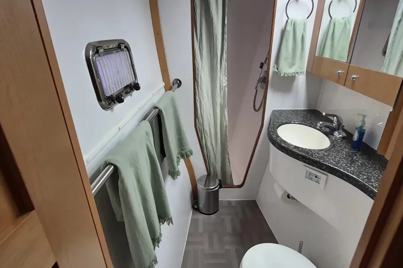 Slide: The Image of Bathroom interior of 2009 Endeavour 40 Skylounge yacht with sink, shower, and towels. - 14