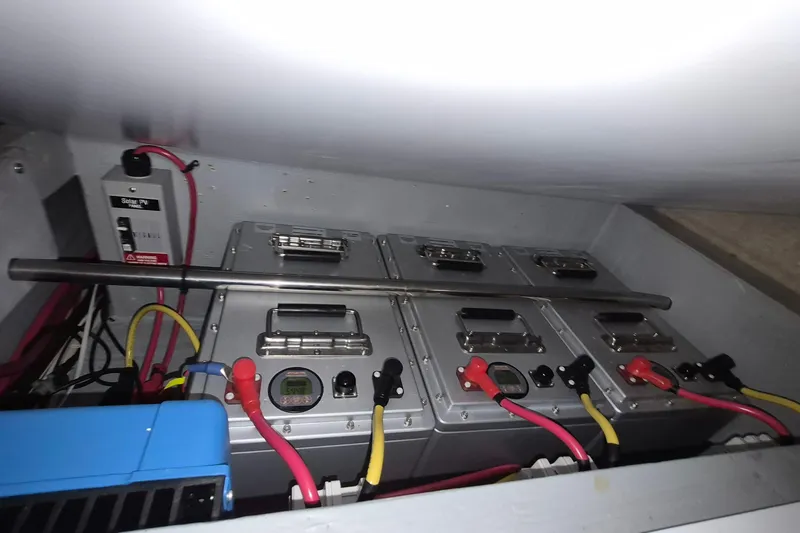 Slide: The Image of Battery compartment of 2009 Endeavour 40 Skylounge with connected cables and control panel. - 18