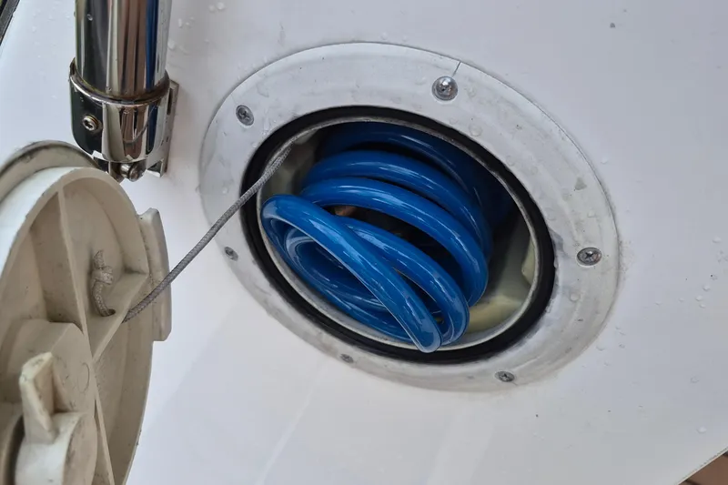 Slide: The Image of Coiled blue hose in Endeavour 40 Skylounge, 2009 model, boat compartment. - 27