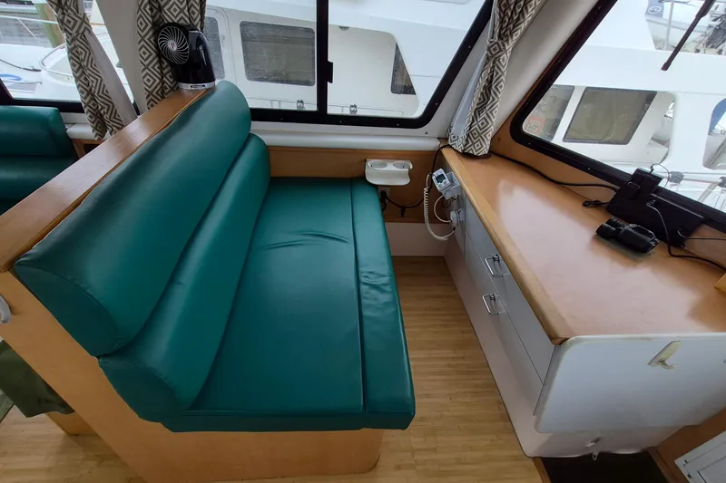 Slide: The Image of Interior of 2009 Endeavour 40 Skylounge with green seating and wooden desk. - 3