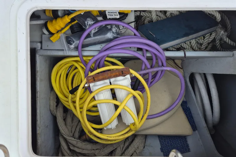 Slide: The Image of Storage compartment with yellow and purple cables on Endeavour 40 Skylounge, 2009 model. - 31
