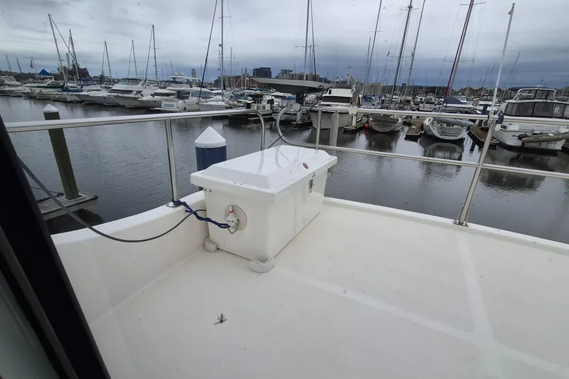 Slide: The Image of 2009 Endeavour 40 Skylounge yacht docked at marina with boats in background. - 39