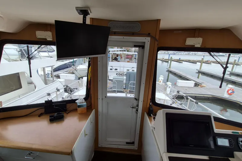 Slide: The Image of Interior view of 2009 Endeavour 40 Skylounge yacht with marina in background. - 4