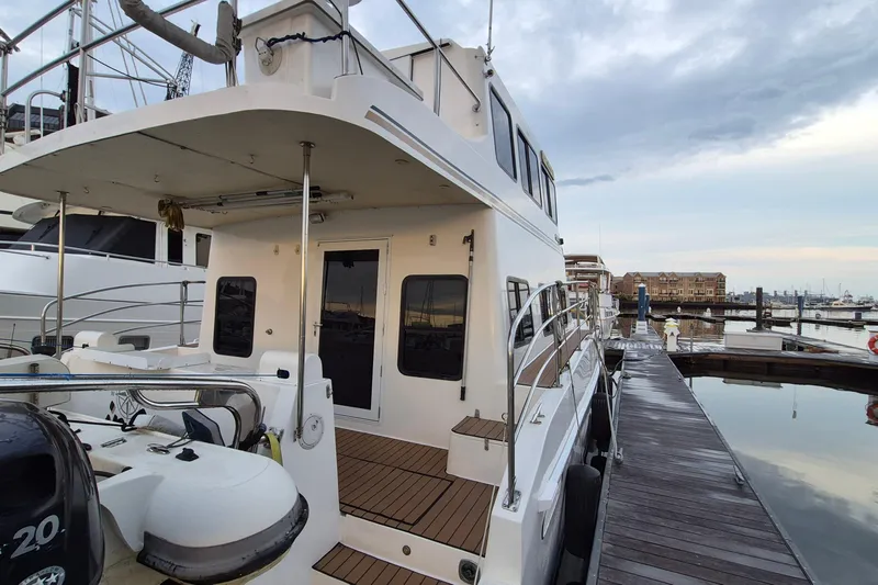 Slide: The Image of 2009 Endeavour 40 Skylounge yacht docked at marina, showcasing sleek design and spacious deck. - 41