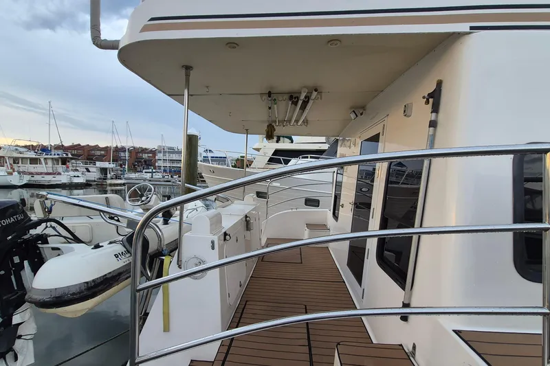 Slide: The Image of 2009 Endeavour 40 Skylounge yacht docked at marina, featuring spacious deck and sleek design. - 42