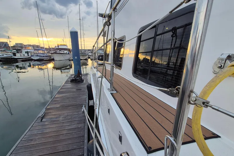 Slide: The Image of 2009 Endeavour 40 Skylounge yacht docked at marina during sunset. - 45