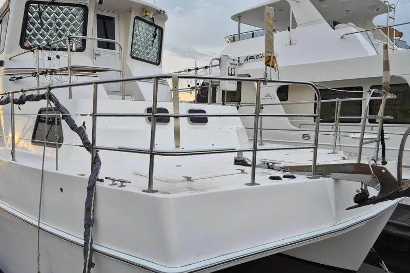 Slide: The Image of 2009 Endeavour 40 Skylounge yacht docked, featuring spacious deck and sleek design. - 46
