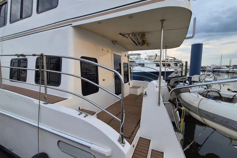 Slide: The Image of 2009 Endeavour 40 Skylounge yacht docked, featuring sleek design and spacious deck area. - 48