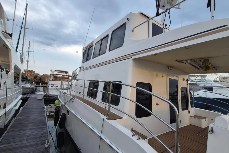 Slide: The Image of 2009 Endeavour 40 Skylounge yacht docked at marina, showcasing sleek design and spacious deck. - 50