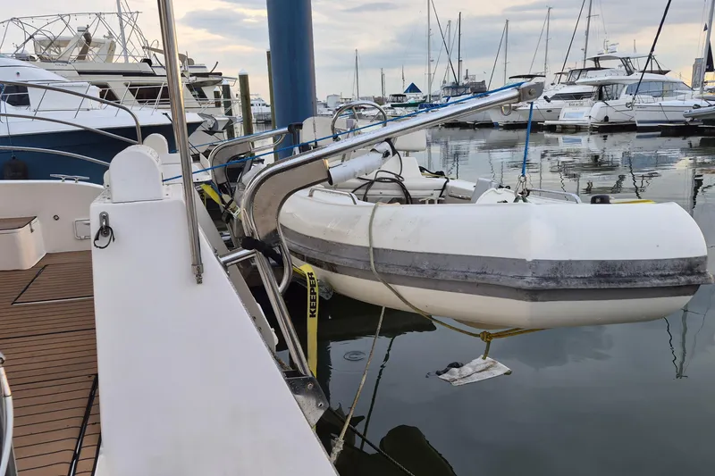 Slide: The Image of Docked Endeavour 40 Skylounge yacht with inflatable dinghy, 2009 model, in a marina setting. - 51
