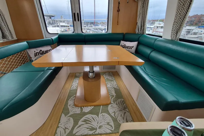 Slide: The Image of Luxurious interior of 2009 Endeavour 40 Skylounge with green seating and wooden table. - 6