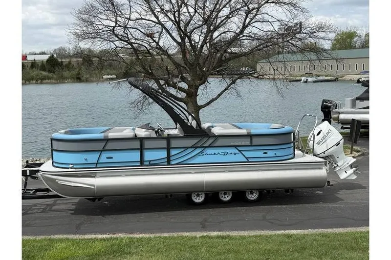 The Image of 2026 South Bay 224 RS 3.0 Hybrid Arch pontoon boat by a lake. - 1